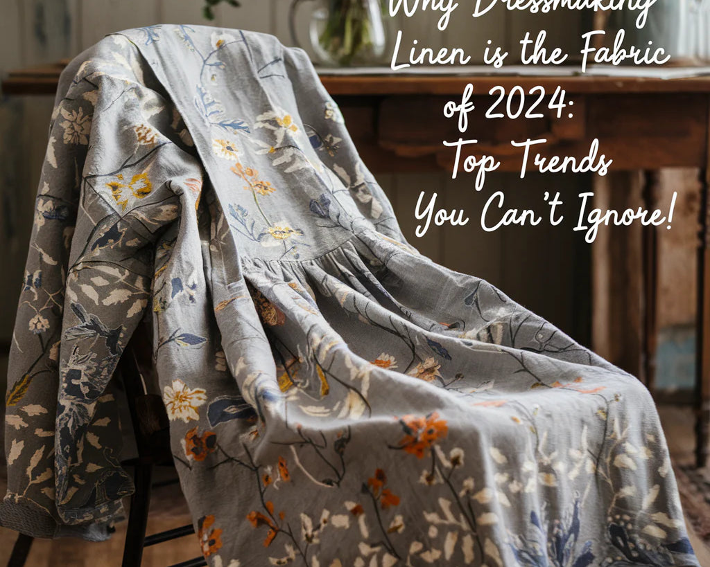 A photo of a dress made from linen fabric. The dress has a floral pattern and is draped over a chair. In the background, there's a wooden table with a vase of flowers.