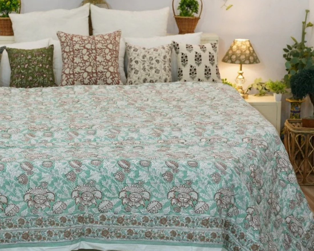 Block print room decor styled with linen cushions, curtains, and table runners showcasing intricate hand-printed designs.