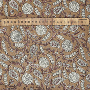 Hand-stamped Indian art on brown natural linen blend fabric, displayed on a farmhouse table and matching curtain in neutral earthy tones.