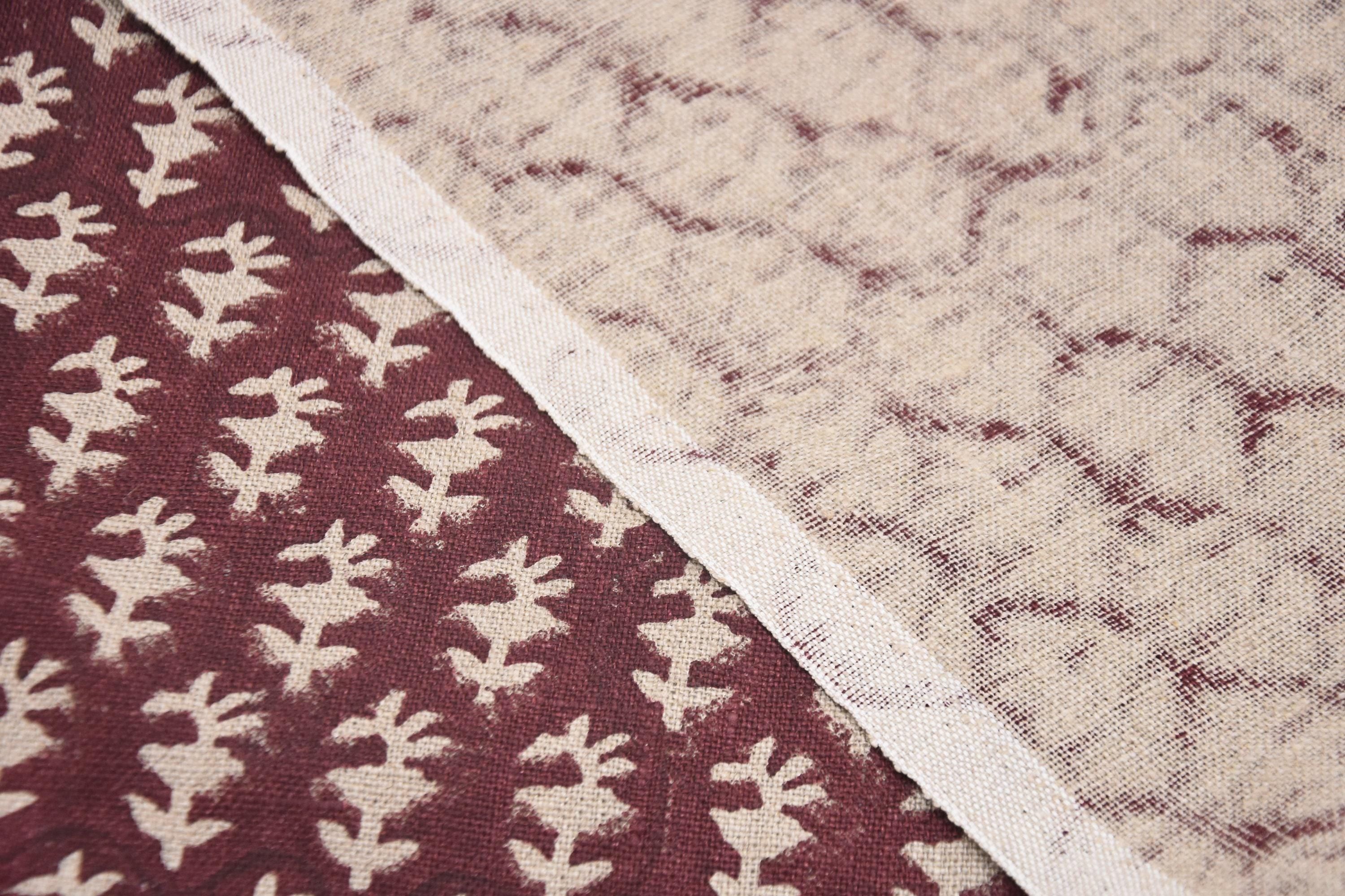 Three soft grey baskets with embroidered florals and fabric handles, aligned by size.