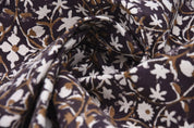 Close-up of patterned fabric with floral design on a dark background