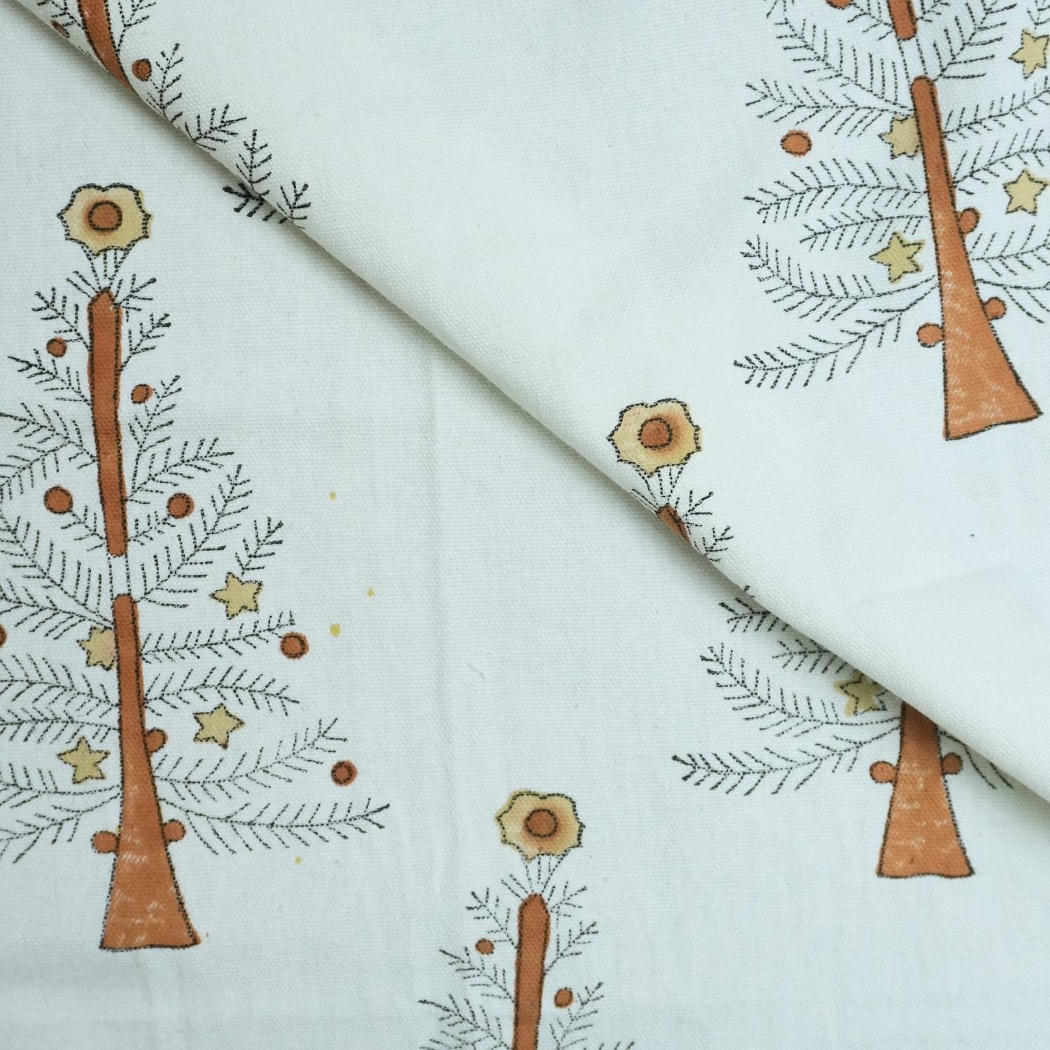 Christmas tree block print fabric  with tree and flower pattern on a white fabric