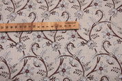 Floral patterned fabric with a wooden ruler for scale