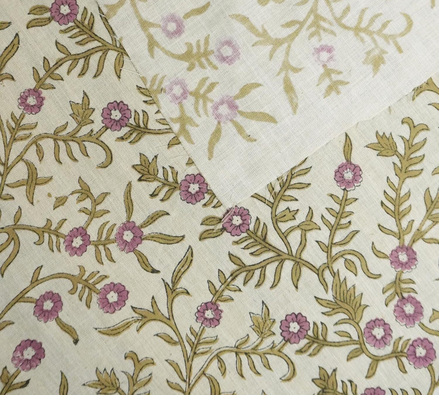 Floral pattern with pink flowers and green leaves on a beige background