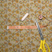 Floral-patterned fabric with a measuring tape and scissors on top