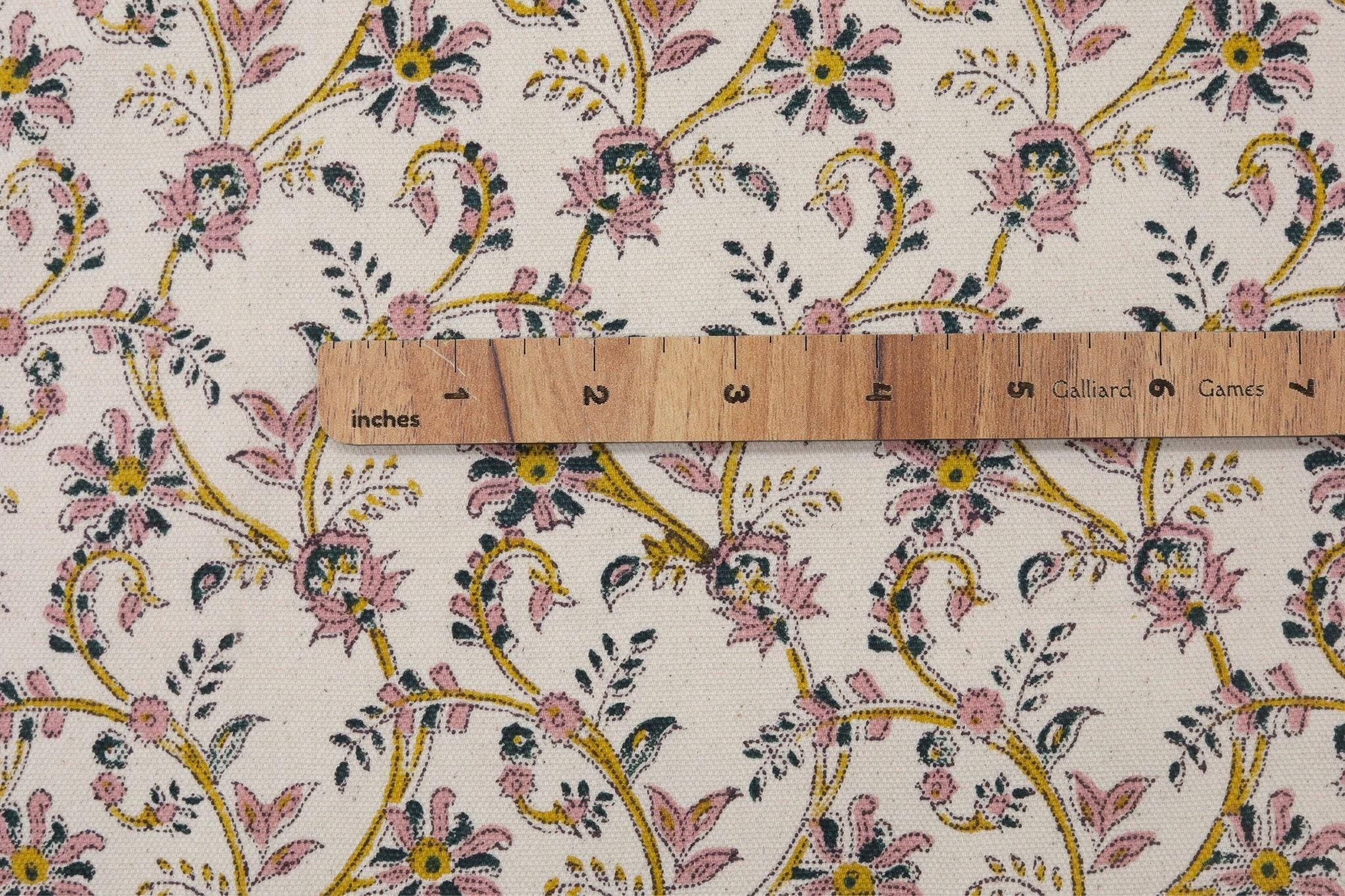 Floral patterned fabric with a ruler for scale on a white background