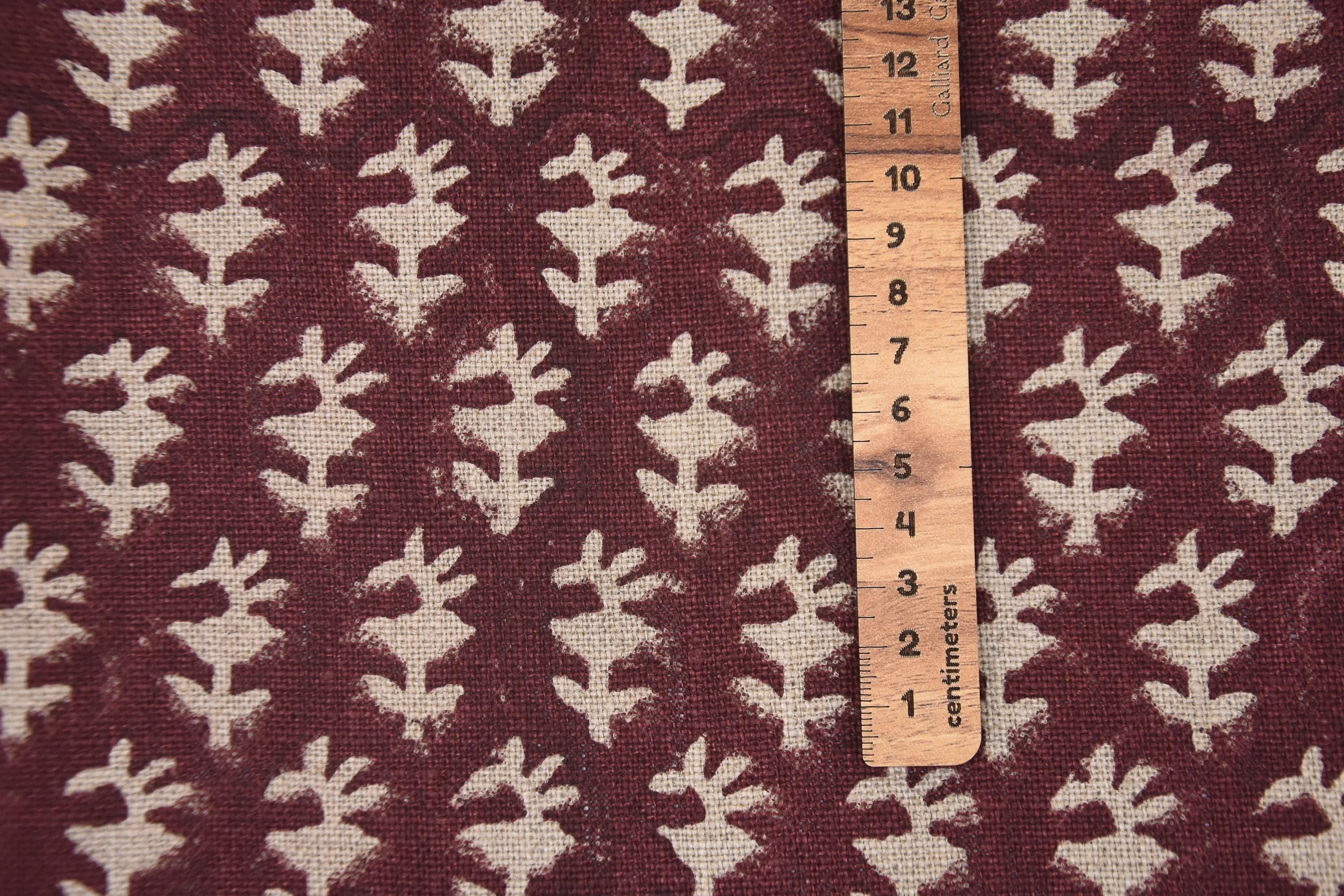 Beige canvas baskets with dark brown checks and tassel accents, placed from large to small.