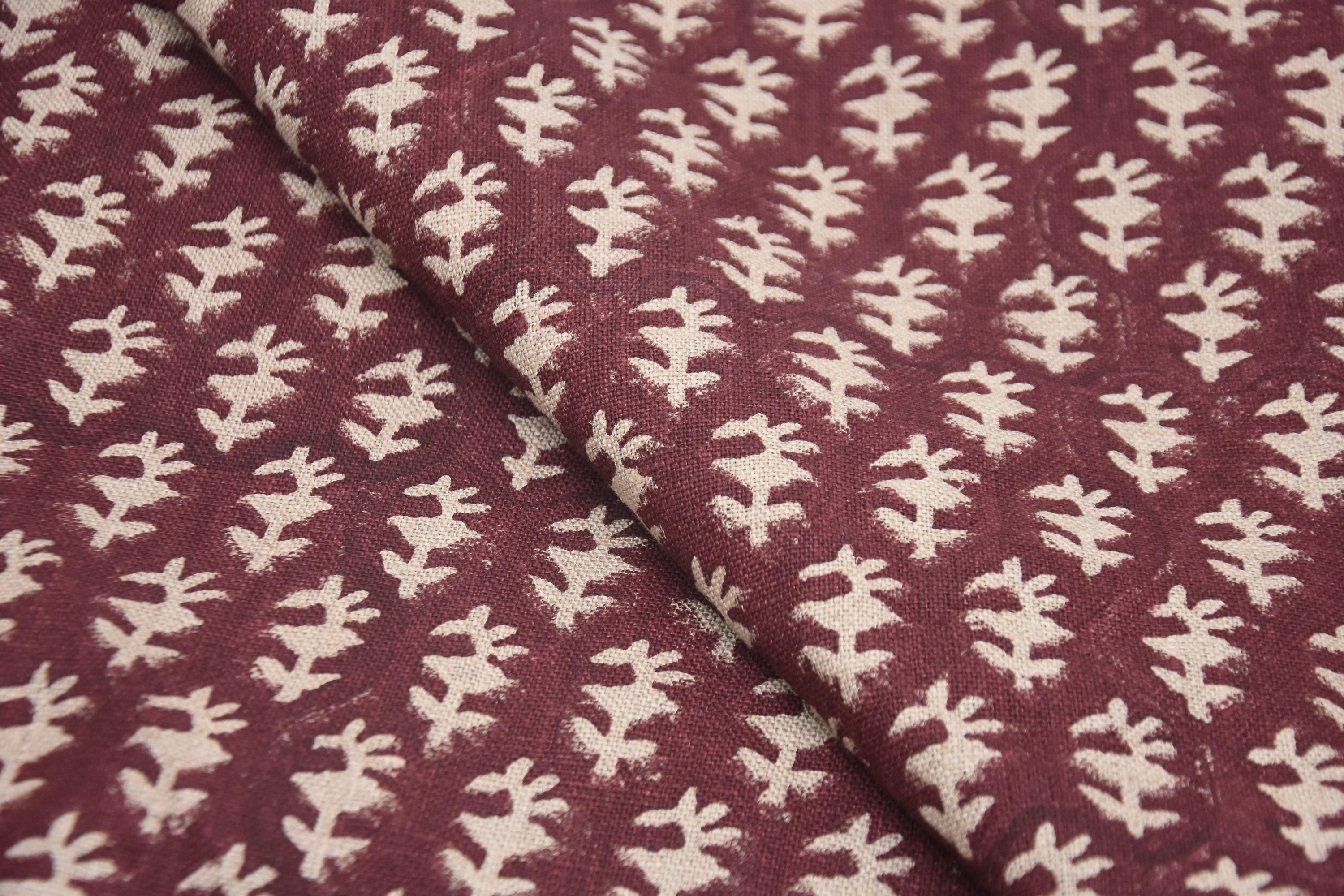 Three ivory jute baskets with navy stripes and drawstring lids, laid out by size.