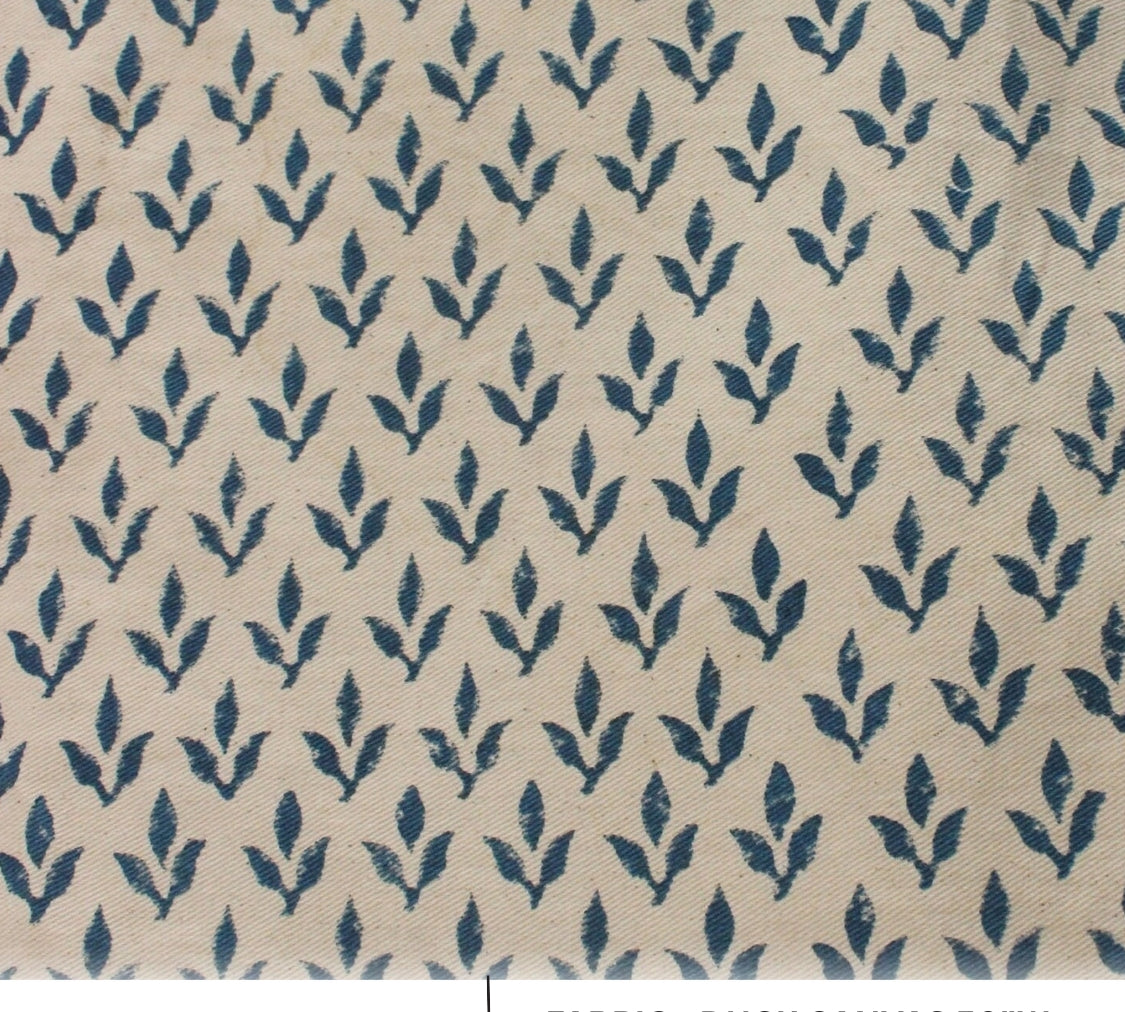 Patterned fabric with blue leaf design on beige background