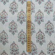 Fabric with a pattern of geometric shapes and a wooden ruler for scale.