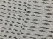 Close-up shot of BAIKUNTH's monochrome striped material