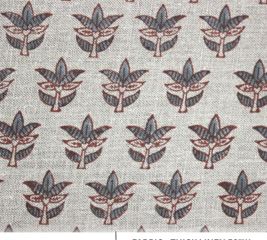 Patterned fabric with leaf design on a light background