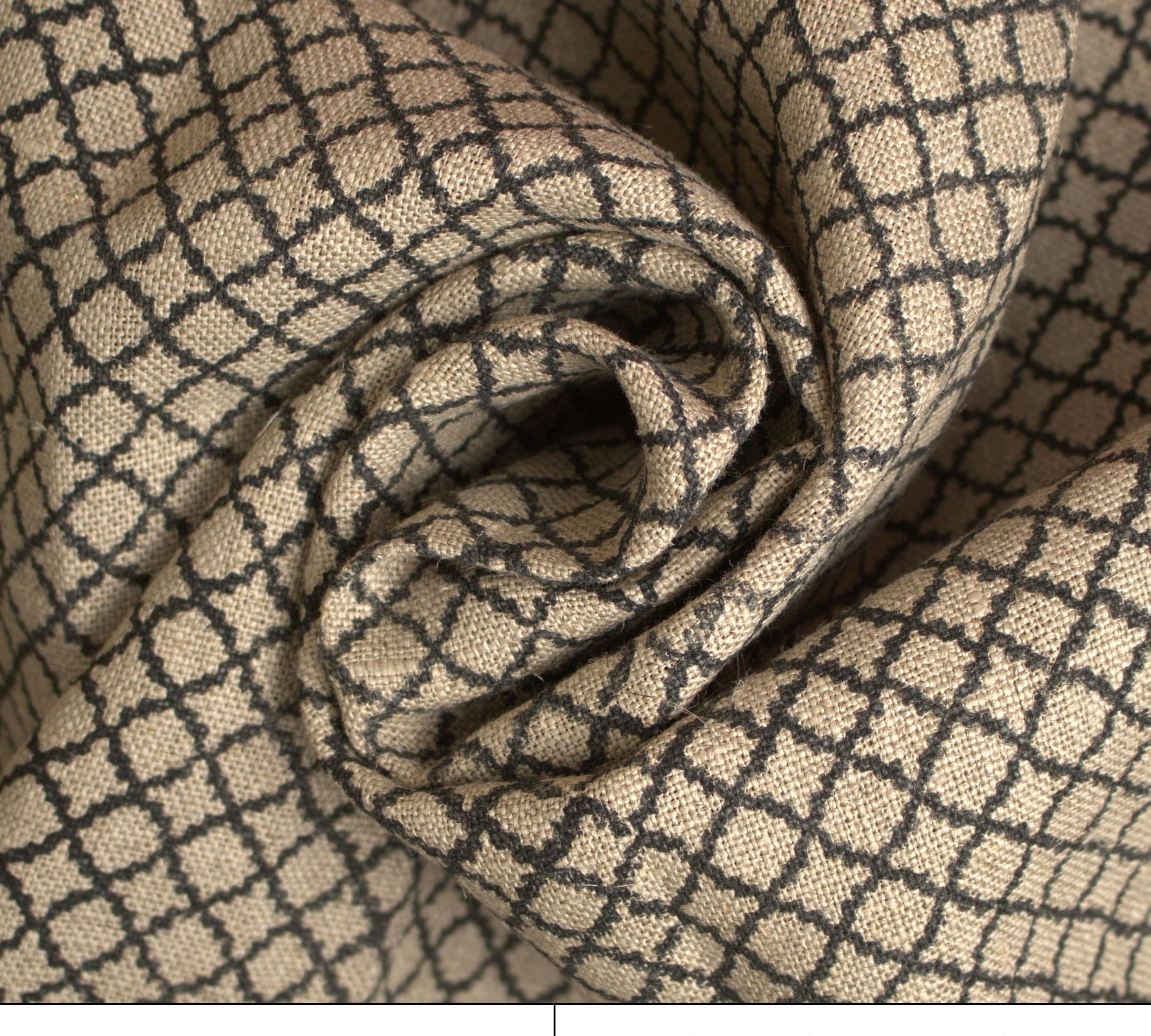 Rolled-up fabric with a geometric pattern on a beige background