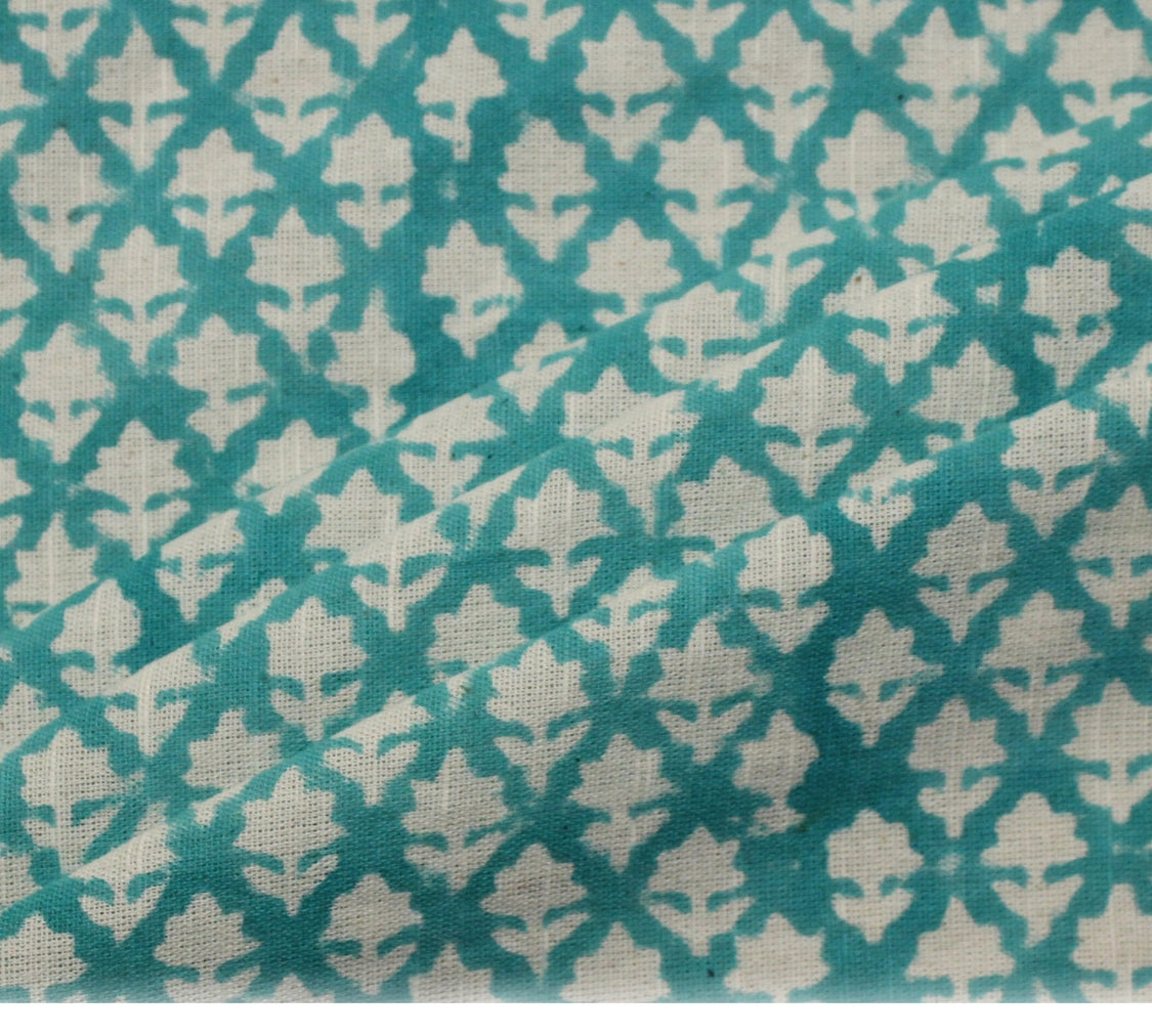 Patterned fabric with geometric design on a teal and beige background